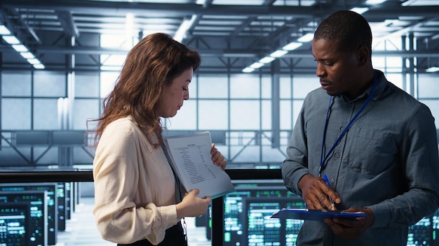 team of it professionals looking over data center checkup checklist paperwork