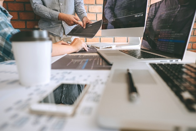 Team of Professional Developer programmer cooperation meeting and brainstorming and programming in website working a software and coding technology, writing codes and database