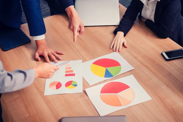 Teamwork with business people analysis cost graph in meeting room