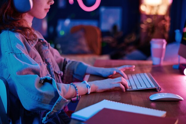 Teen girl playing on computer
