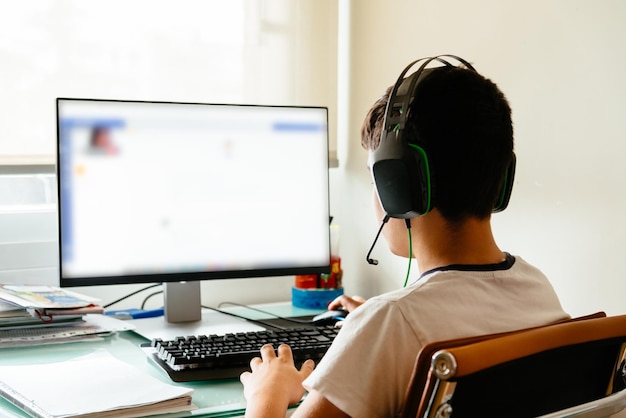 teenager is studying at home attending online classes