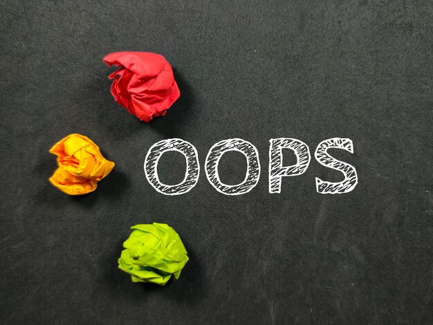 Text OOPS with torn paper on a black background