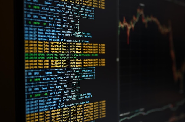 The computer screen shows Ethereum miner Concept of cryptocurrency mining Miner software running and showing current crypto exchange rates on a PC Monitor in the background