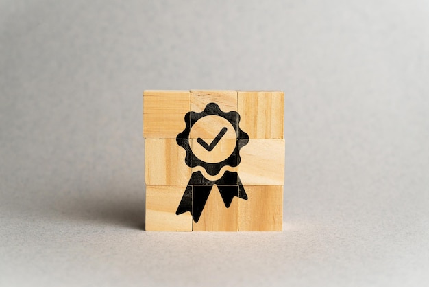 The concept of quality and standards Icon with a sign on wooden cubes
