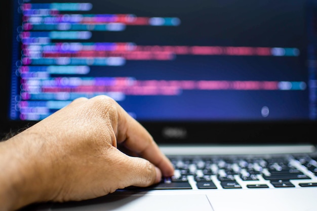 The programmers hand is writing the source code Programmers write programs