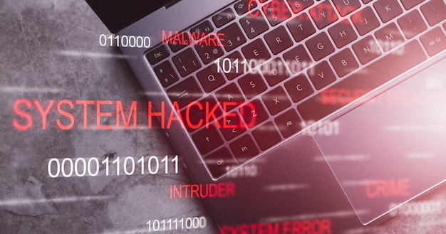 top view desk of laptop keyboard with system hacked alert vr screen compromised information concept