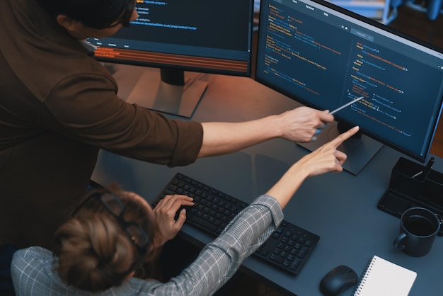 Top view IT developers discussing with point website coding system Infobahn