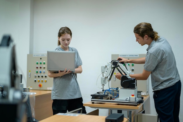 trainee robotics engineer learning with programming and manipulating robot hand automatics