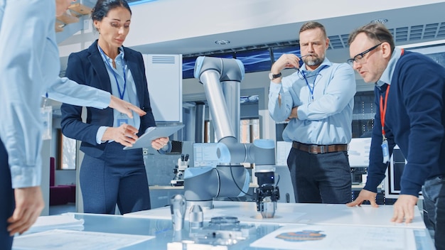 Two people in a lab looking at a robot