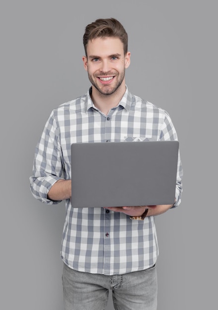 university student using laptop for studying online happy man typing laptop computer
