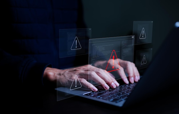 user or it staffs programmer developer using computer laptop with triangle caution warning sign for notification error and maintenance concept virus detected warning computer bugs software bug