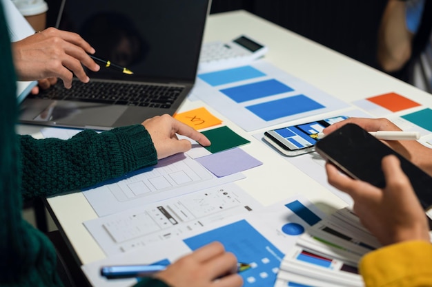 UX developer and ui designer brainstorming about mobile app interface wireframe design with customer breif and color code User experience concept