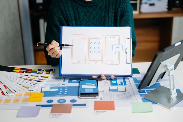 UX developer and ui designer brainstorming about mobile app interface wireframe design with customer breif and color code xA