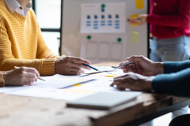 ux ui designers collaborate to design user interfaces for smartphone apps based on user experience colleagues meeting program designers brainstorm to discuss designing mobile applications