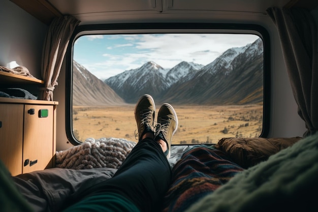 view from inside a camper of crossed legs with the mountains in the background