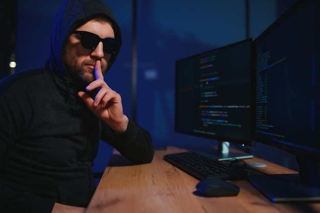 wanted hackers coding virus ransomware using laptops and computers cyber attack system breaking and malware concept