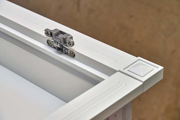 white cabinet with hidden hinges and shelf holders closeup wooden furniture manufacturing process