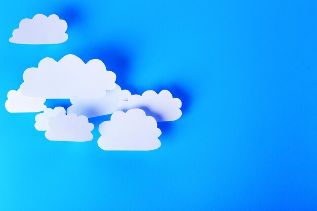 White paper clouds on blue background Cloud computing concept