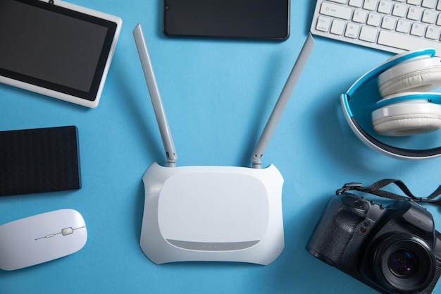 Wi fi router with a tablet phone computer keyboard and other objects