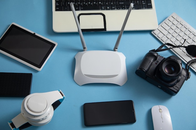 Wi fi router with a tablet phone computer keyboard and other objects