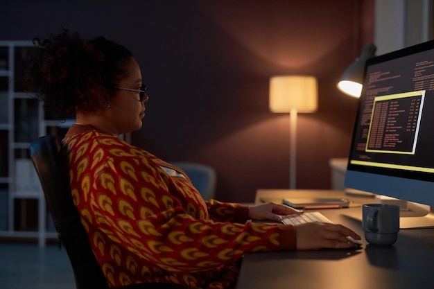 Woman working with computer codes in office