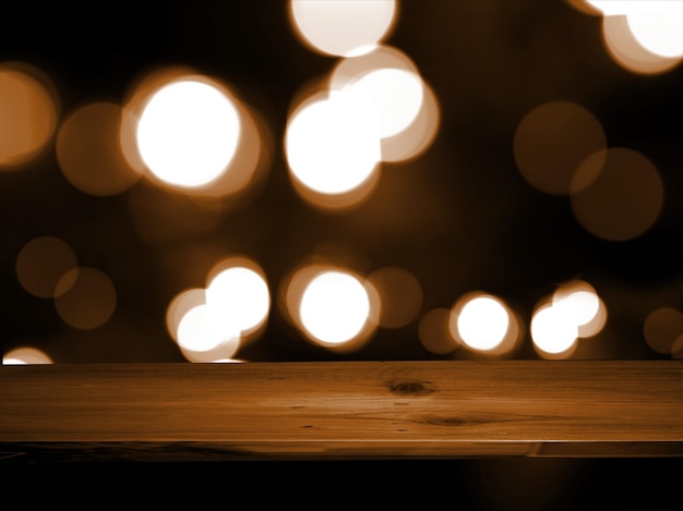 Wooden table and bokeh from neon lights glowing behind