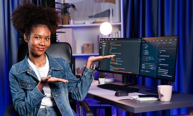 Young African IT developer presenting program and focus on camera Tastemaker
