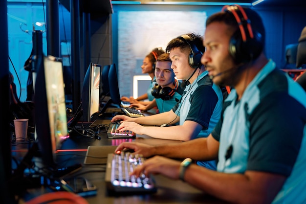 Young asian man gaming with his friends in cyber club