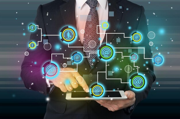Young businessman showing social networking technology with colorful lights