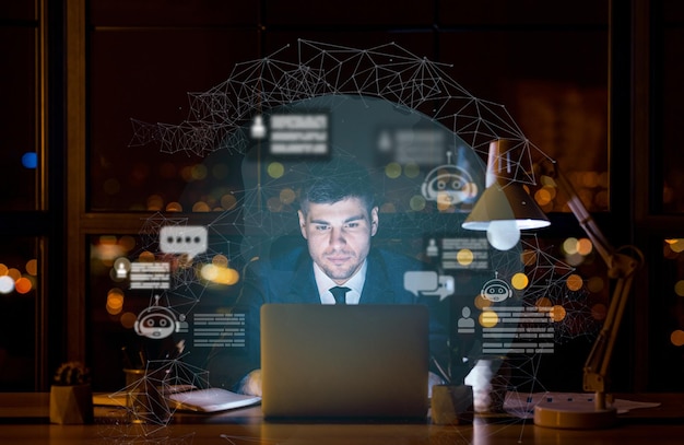 Young businessman working on laptop at dark office using chatbot