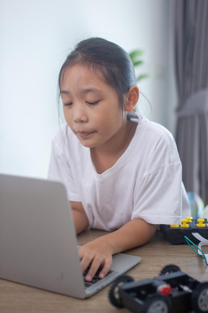 Young girl working on a robot design