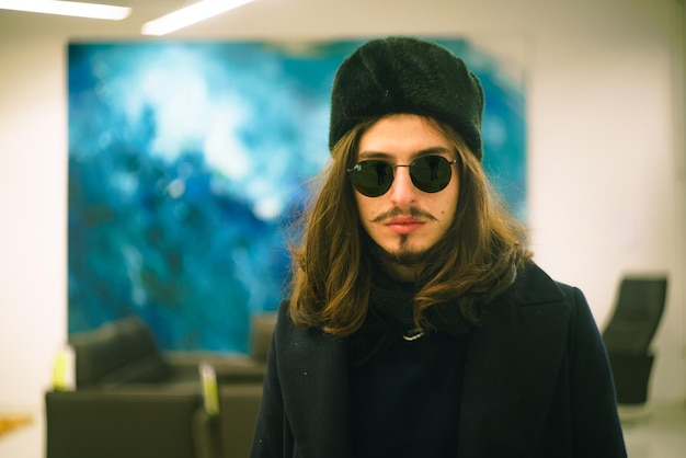 young man with long hair wearing sunglasses