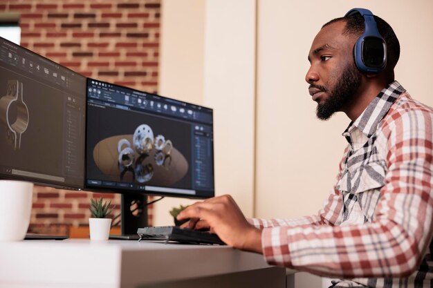 African american engineer prototyping gears model on manufacturing software, developing engine product for technical industry innovation. Creating turbine design with industrial cad science.