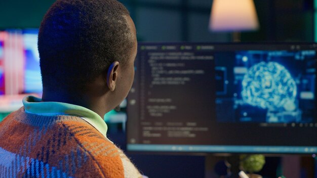 african american man working on computer to write code and programming