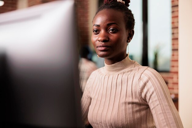 african american programmer brainstorming ideas to write code and create new interface in data room. system engineer programming server database in busy artificial intelligence developing agency.
