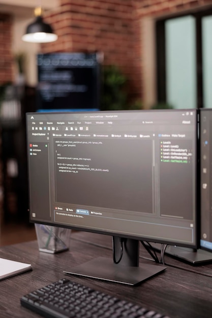 Computer monitors showing source code in empty it company office, security system compiling data algorithms in background. Artificial intelligence servers cloud computing in programming room