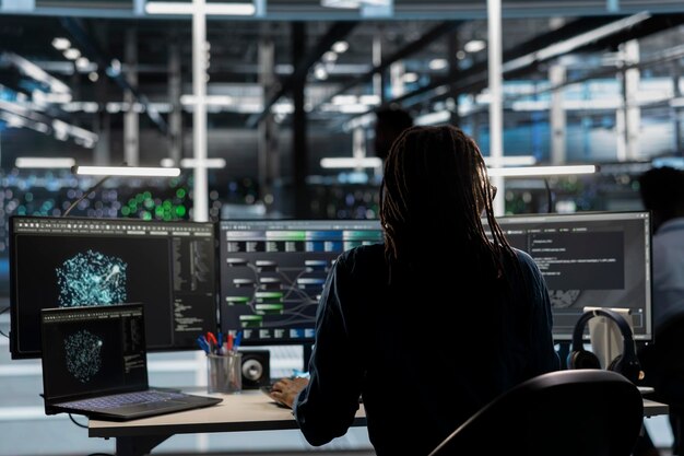 Data center worker using AI deep learning algorithms to analyze large datasets