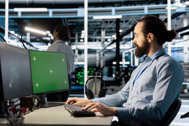 Engineer in data center using green screen mockup PC to update software