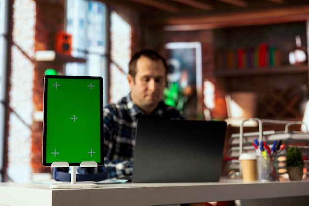 Man in home office using isolated screen tablet preparing presentation slides
