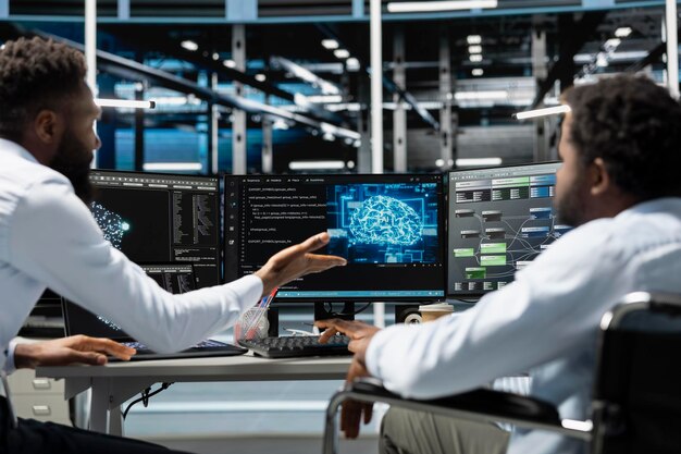 Man in wheelchair and colleague in data center running AI tools