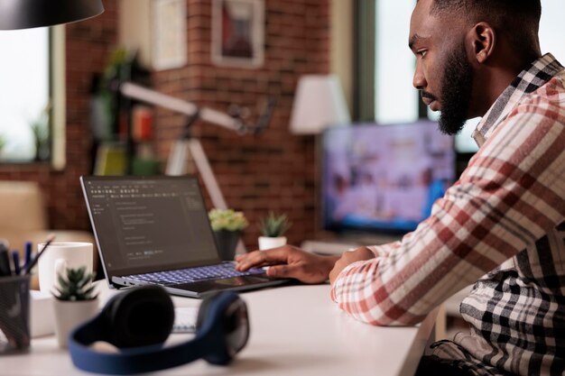 software developer using terminal window app on laptop, learning to code new user interface program. developing cloud computing online server with firewall security and css html script.