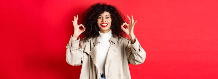 Miễn phí Photo stylish caucasian woman in trench coat showing okay gesture and smiling satisfied recommending compa