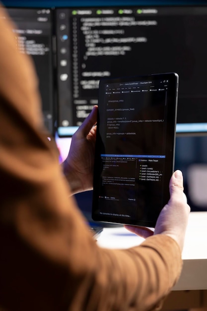 Teleworking programmer designing and developing software using tablet