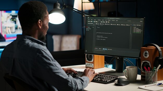 Black man programmer manages code and scripts in artificial intelligence
