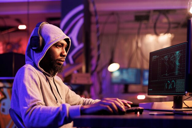 Hacker in headphones writing code