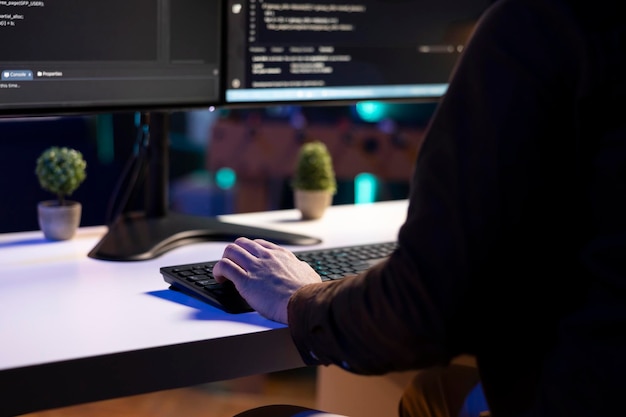 IT admin in apartment fixing coding issues typing on keyboard close up