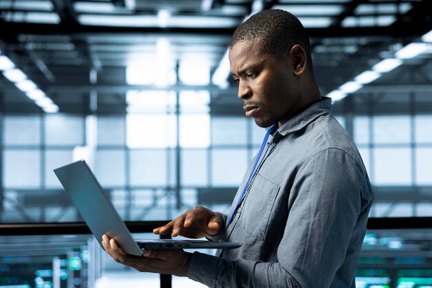 Man in data center adjusting cooling and power settings