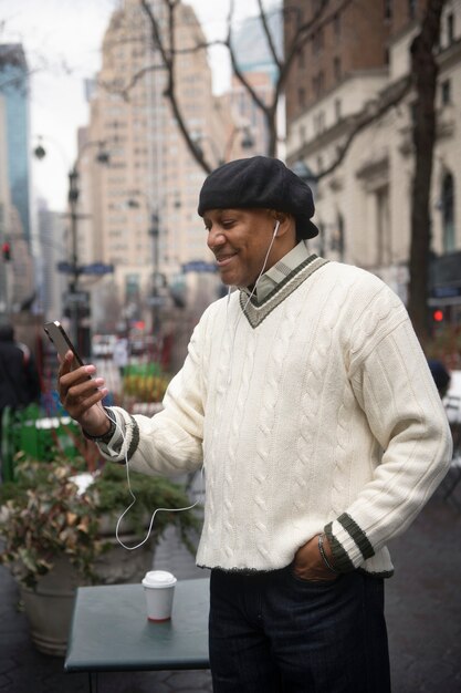 man using technology while traveling in the city