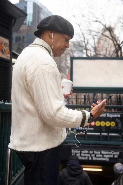man using technology while traveling in the city