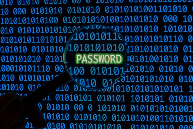Password with binary code and hand holding magnifying glass